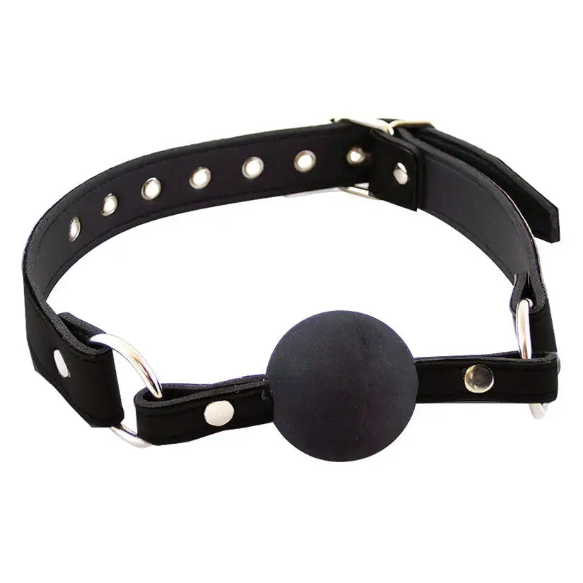 Close-up of a black silicone ball gag with adjustable leather straps, used as a BDSM restraint accessory for bondage play